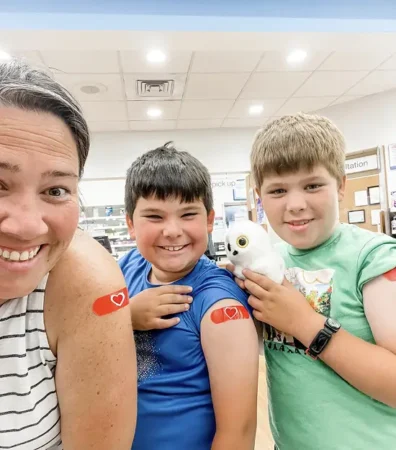 Mom and children showing off their flu vaccines